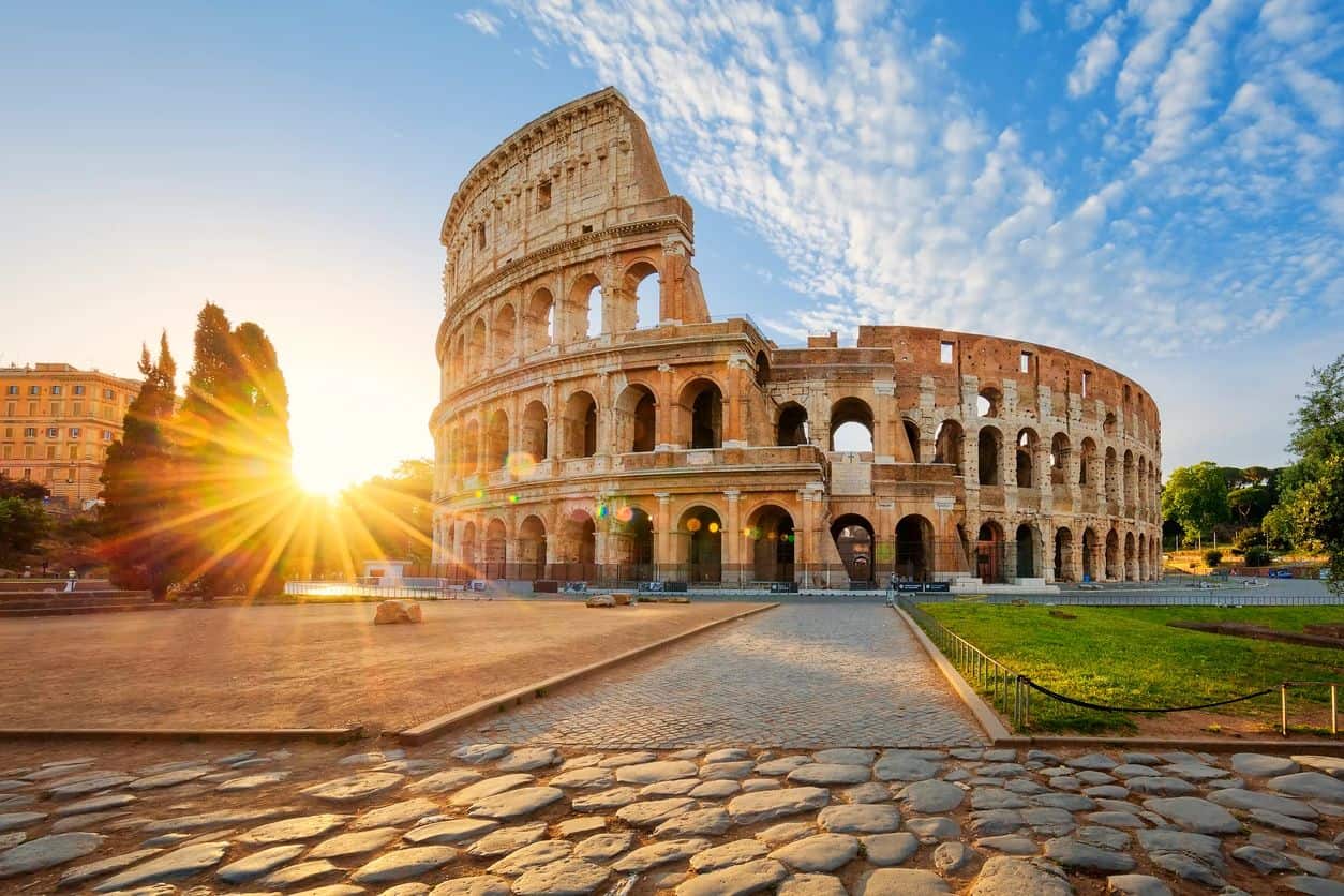 A view of the colosseum in rome at sunset.
